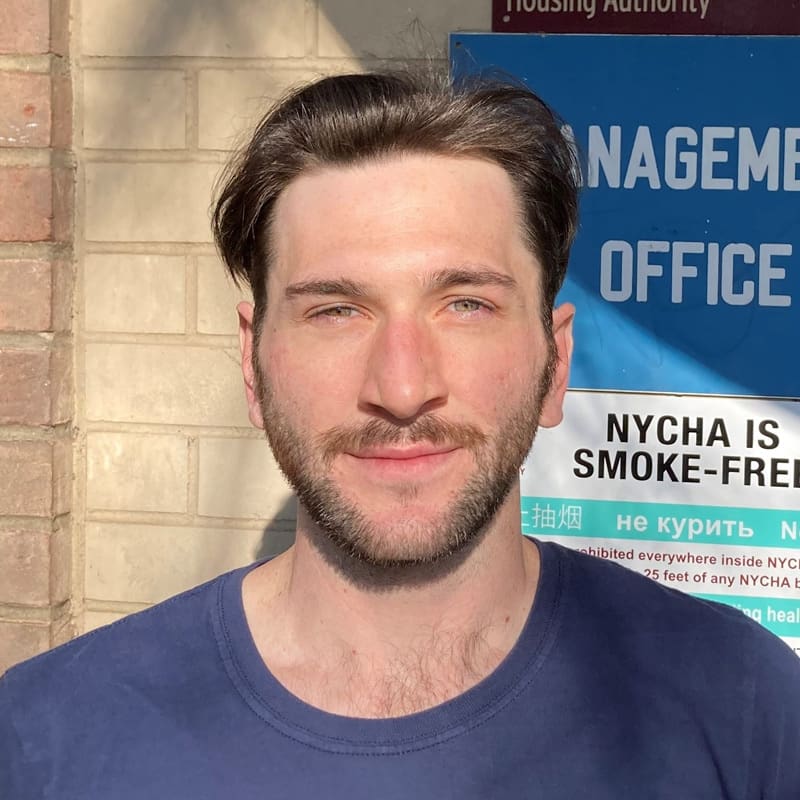Man standing outside a smoke-free management office.