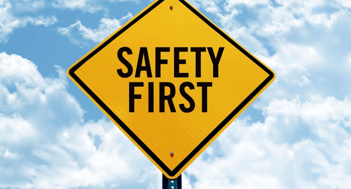 Safety First sign against a cloudy sky background.