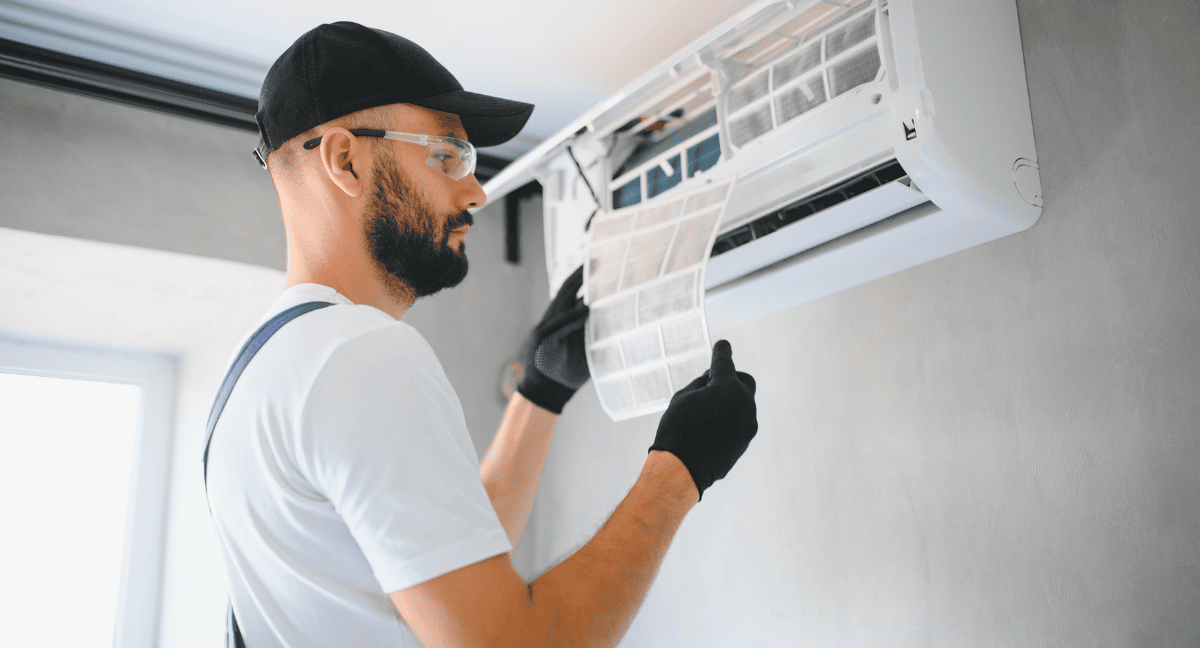 Technician servicing an air conditioning unit.