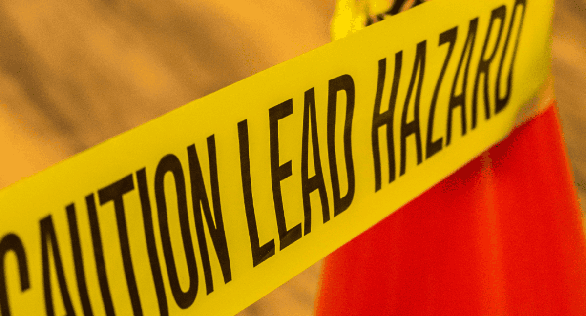 Yellow caution tape with text warning of lead hazard.