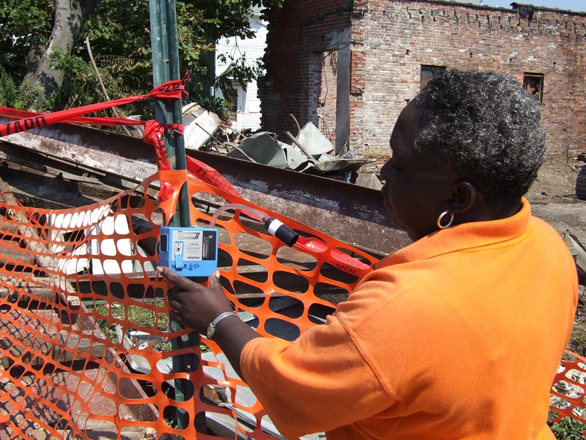 Person inspecting construction site with a handheld device.